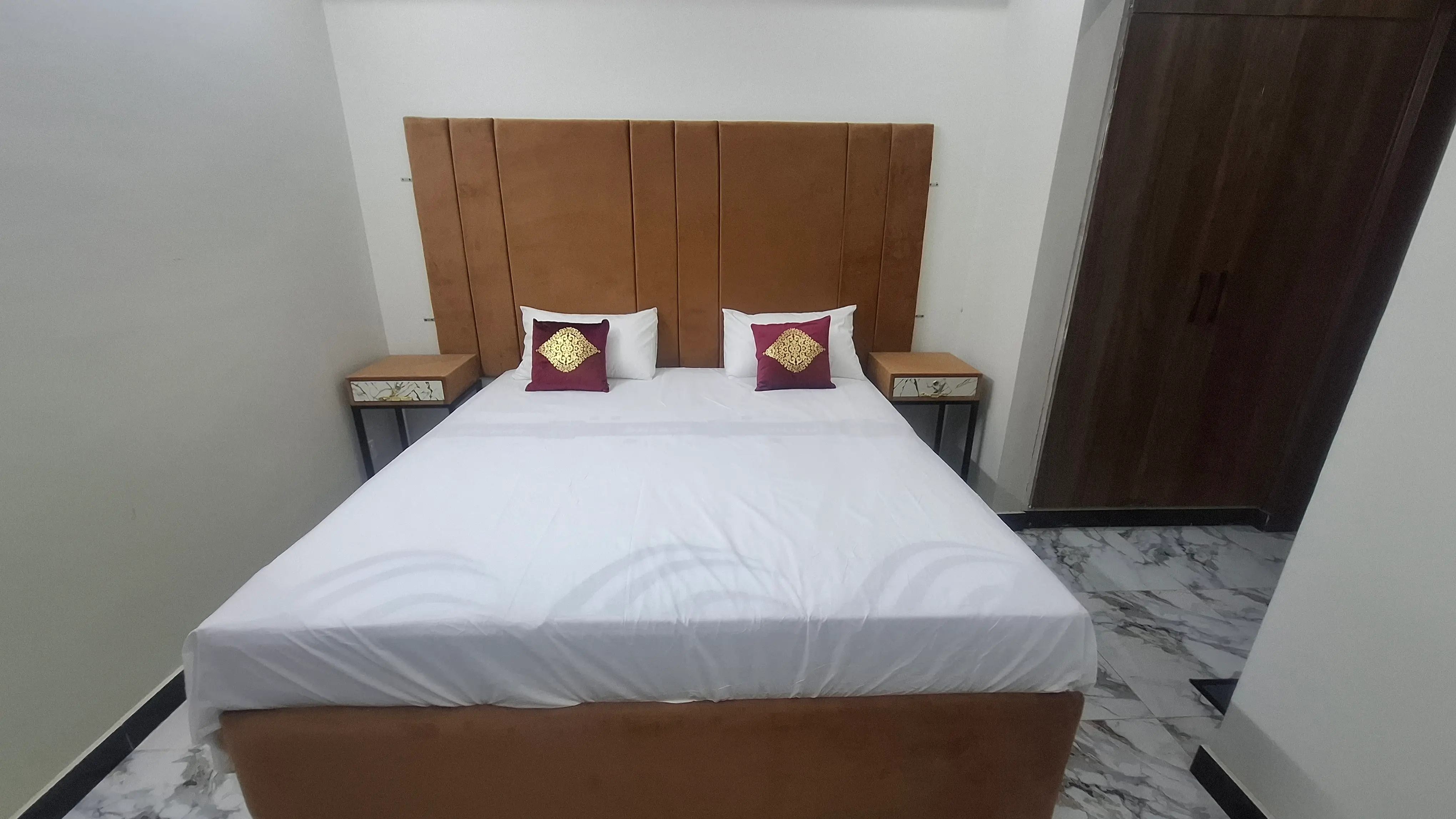 A neat and clean brown king size bed.